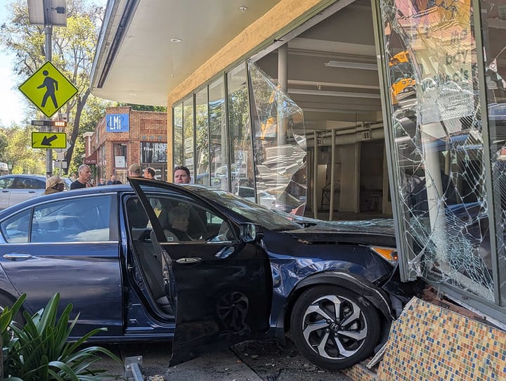 Two-car crash sends Honda into building, investigation ongoing